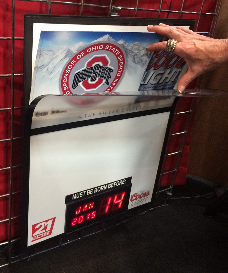 Dry erase board with LED clocks and interchangeable advertising inserts held in magnetically.